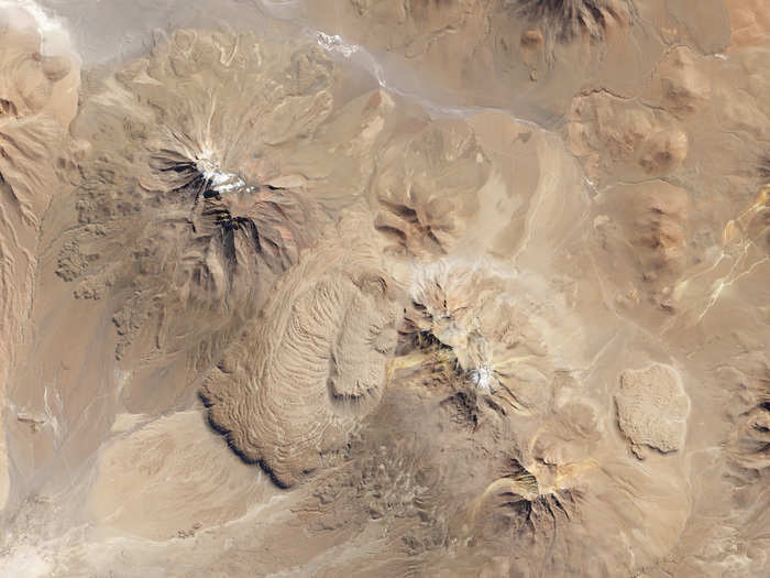 Between these two volcanoes in northern Chile is the Chao dacite, which is a type of lava dome with characteristic ripples that form when exceptionally thick, sticky lava flows onto a steep surface.