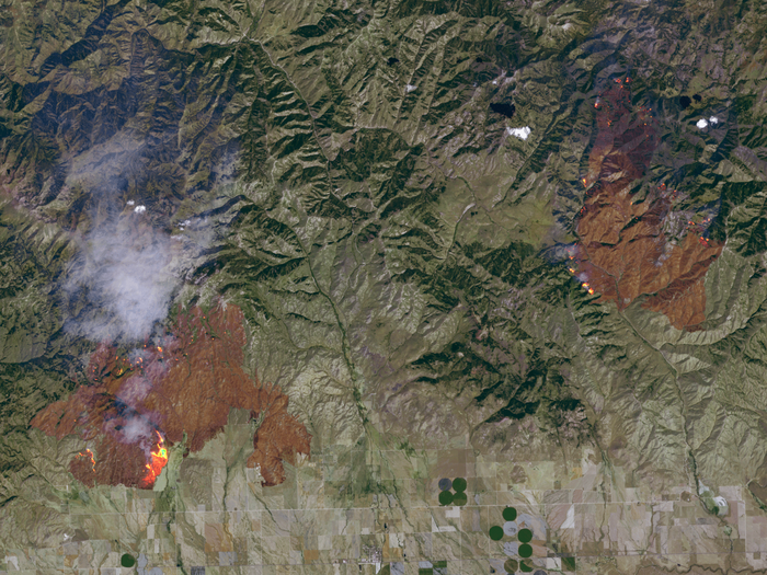 Here, you see active Idaho Wildfires and residual burn scars in the Elk and Beaver Creek Complexes.