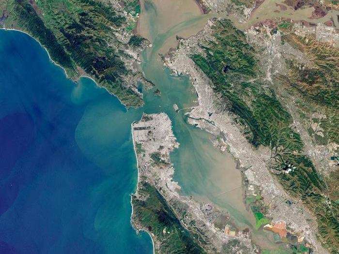 The upper, central pocket of water is the San Pablo Bay that connects to the San Francisco Bay to the south, which then feeds into the Pacific Ocean. You can clearly see how murky, muddy coastal waters make their way out to the surrounding ocean.