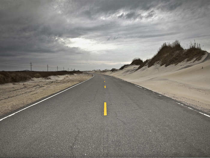 Left to their own devices, barrier islands are able to erode and rebuild through a process called washover, in which waves sweep over the island, pulling sand away from the beach face and depositing it further inland. But manmade structures on the Outer Banks, like roads and bridges, impede this natural process, meaning eroded sand doesn