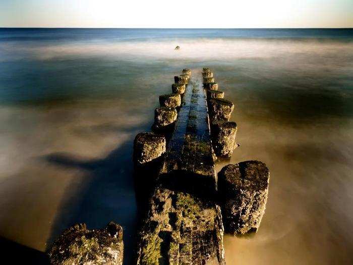 To combat erosion, many coastal communities use "hard structures" like jetties to hold the beach in place. But these structures can actually cause increased erosion further down the beach, and North Carolina has had a ban on these structures since 1985.