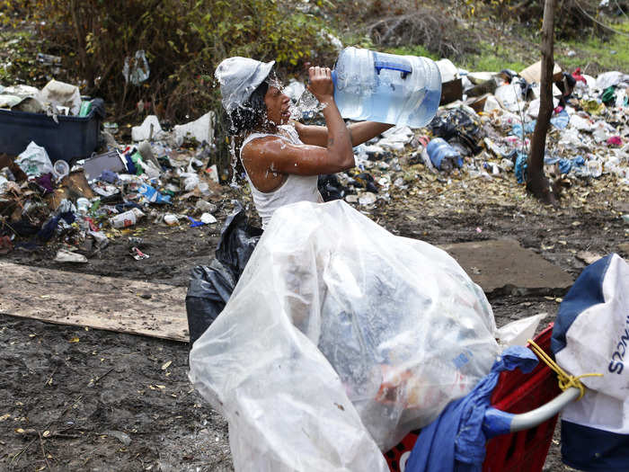 Anna Haynes splashes herself with water before leaving the area.