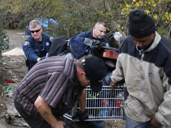 City workers help Bobby Labow bring his things up to the main street.