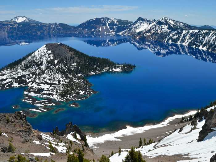 OREGON: Circumnavigate Crater Lake, one of the deepest lakes in the world. The lake, known for its striking blue color, was formed in the caldera of a collapsed volcano.