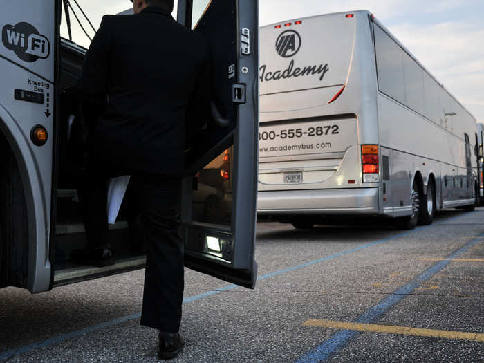 A Naval Academy midshipman finds his bus and prepares to make the early morning ride to Baltimore, Maryland. Attendance is required of all students.