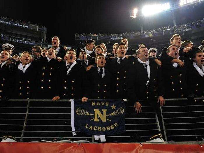 Members of the student section known as "The Pit" cheer on the Midshipmen following a touchdown.