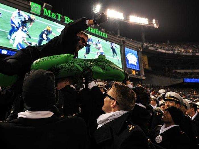 As Navy pulled ahead in the second half, fans went wild. Midshipman Second Class Tom Toohig, a junior at the Naval Academy, gets a lift from his fellow company-mates.