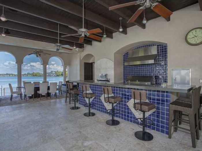 Nearby the pool is a second, open-air kitchen.