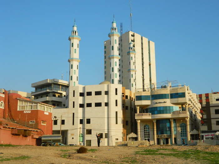 Although this mosque along the waterfront is only partially built, its minarets still broadcast the call to prayer five times each day.