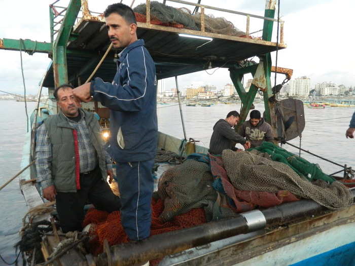 At the nearby port, a crew of fishermen prepare to depart the port at sunset. Israeli-enforced restrictions meant to prevent weapons smuggling limit the fishing area to six miles from shore. The boats run on antiquated diesel engines and have no radar or communications equipment onboard.