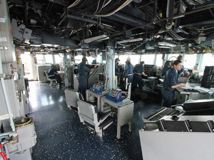 In a time of conflict the order to fire the gun comes from here: the bridge of the USS Barry. But getting the weapon to fire and making sure it hits the target requires coordination among people all over the ship.