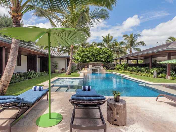 They even have a waterfall, lounge chairs, and sun umbrellas set up on the deck.