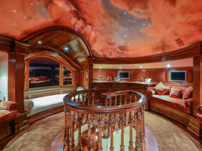 At the very top of the house is this round reading room with a painted ceiling.