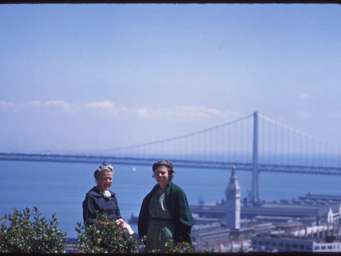Here, two women pose with the Bay Bridge.