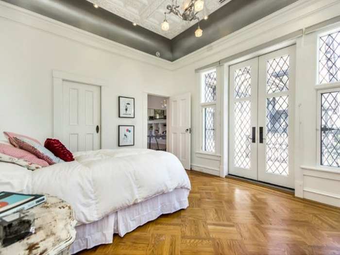 All of the bedrooms have interesting details, like the carved ceiling, unique chandelier, and private terrace seen here.