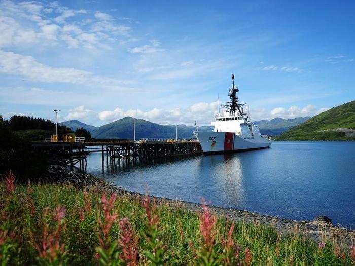 The Alaskan wilderness also offers thousands of square miles of unspoiled natural beauty. Here, a Coast Guard ship makes port call at Kodiak.