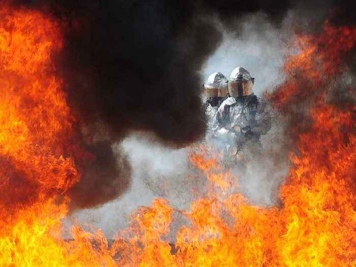 Here, members of the Coast Guard Fire and Rescue team battle a simulated fire, to prepare for an actual aircraft fire emergency.