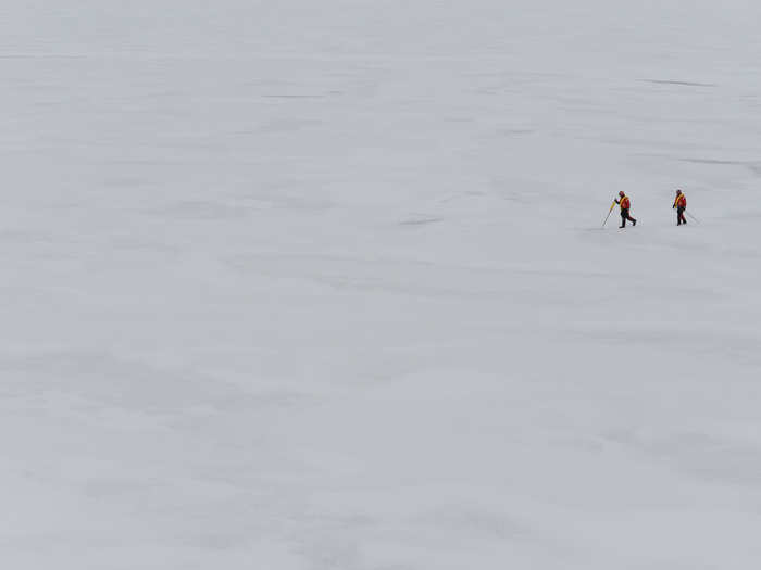 Members of an ice rescue team survey an ice sheet before allowing crew and passengers of a vessel to disembark.