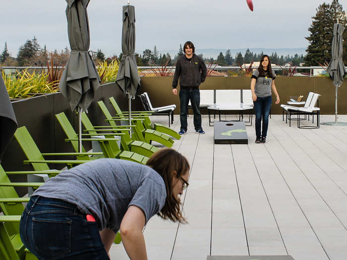 On the roof, monkeys played corn hole to celebrate the end of the work week.