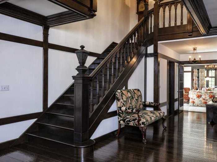 The home was built in 1934 but underwent extensive renovations in the 1980s. Certain features, like this dark wood staircase, show signs of the home