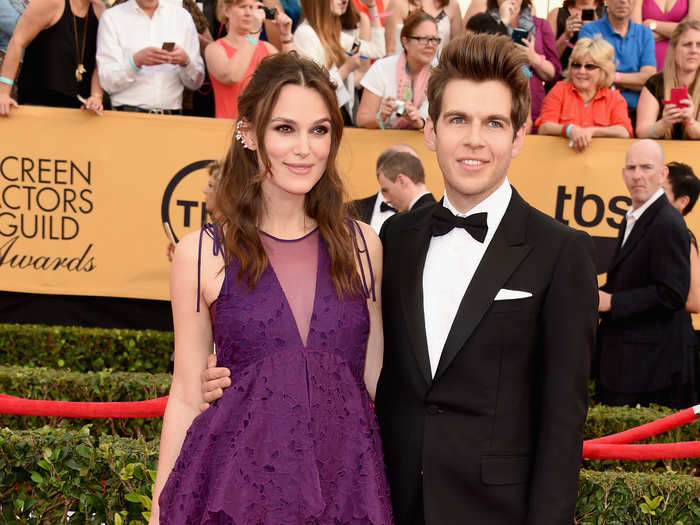 Pregnant "Imitation Game" nominee Keira Knightley, wearing an Erdem dress, with musician James Righton.