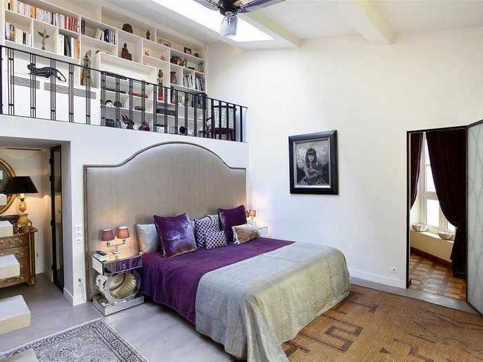 This bedroom (one of three) emphasizes the high ceilings, with a convenient loft storage space above the bed.