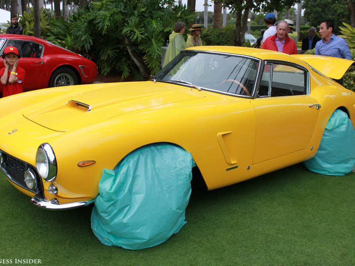 Things were pretty soggy on the lawn. This 1962 Ferrari 250 GT SWB Berlinetta had its wheels covered for protection from the rain.