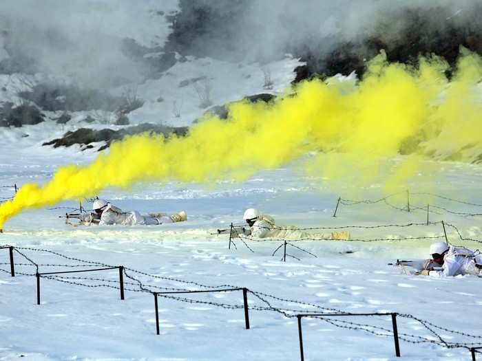 These shooters are practising among smoke bombs.