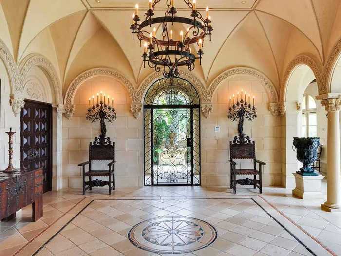 Insider, the foyer impresses with details like a grand chandelier, custom tiling, and a eye-catching domed ceiling.