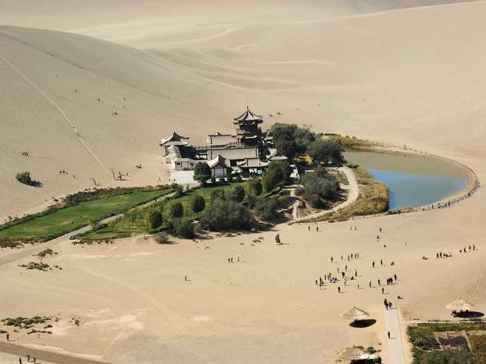 Ride a camel over the sand dunes of the Gobi Desert to get to Crescent Lake in Dunhuang.