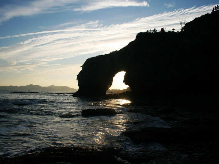 Swim with the animal-like rock structures at Golden Pebble Beach in Dalian.