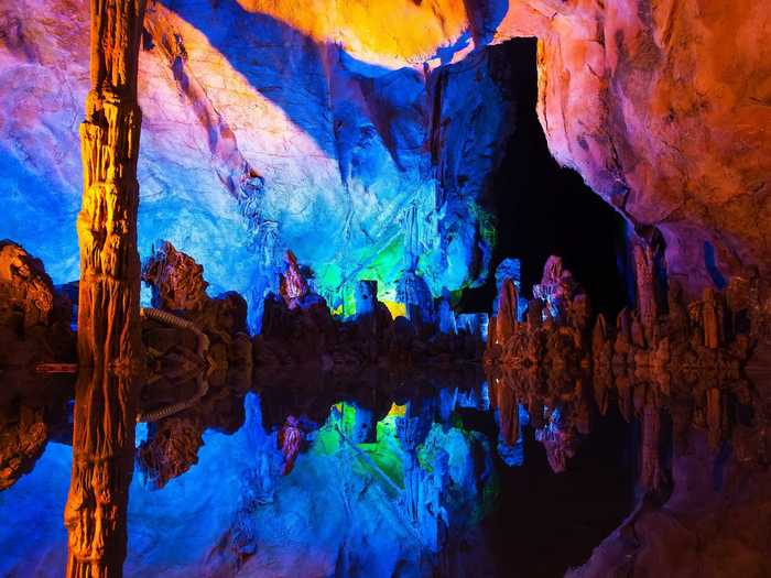 Explore the illuminated stalagmites and stalactites of the Reed Flute Cave in Guilin.