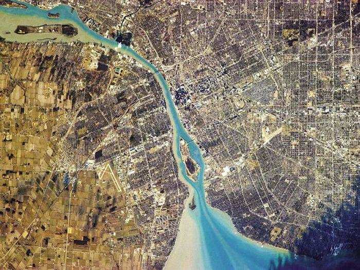 "The human impulse to impose order on Nature is apparent everywhere in North America," Hadfield writes. Here, he shows a stretch of the Detroit River separating Detroit, Michigan on the right from Ontario, Canada on the left.