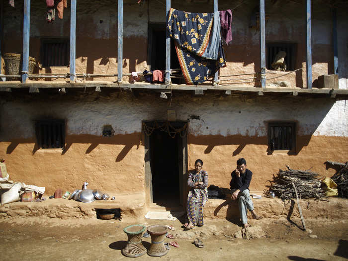 For others, the lesson is learned too late. Here, Yagraj Bhul and his wife, Ishwora Bhul, stand outside their house, not far from the abandoned shed where their 15-year-old daughter died practicing chaupadi a year ago.