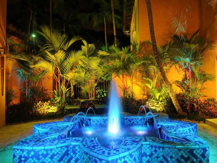 A mosaic fountain in the courtyard lights up at night.