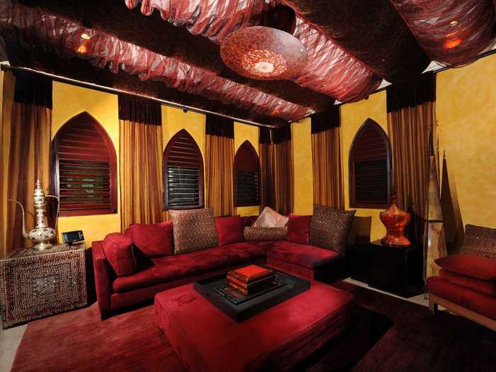 Deep red couches and exotic-looking lamps add to the effect.