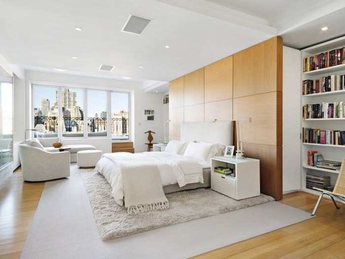 The master bedroom has built-in bookshelves, huge windows, and space enough for a sitting area.