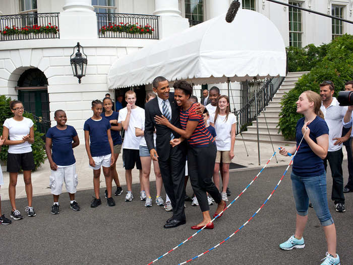 Barack congratulates Michelle after she jump-ropes during a July 2011 White House Presidential Active Lifestyle Award event.