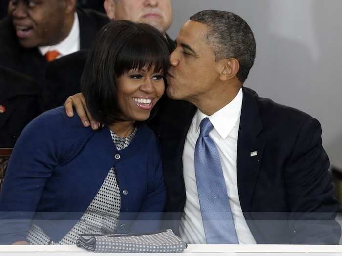 Barack gives Michelle a kiss during the inaugural parade.