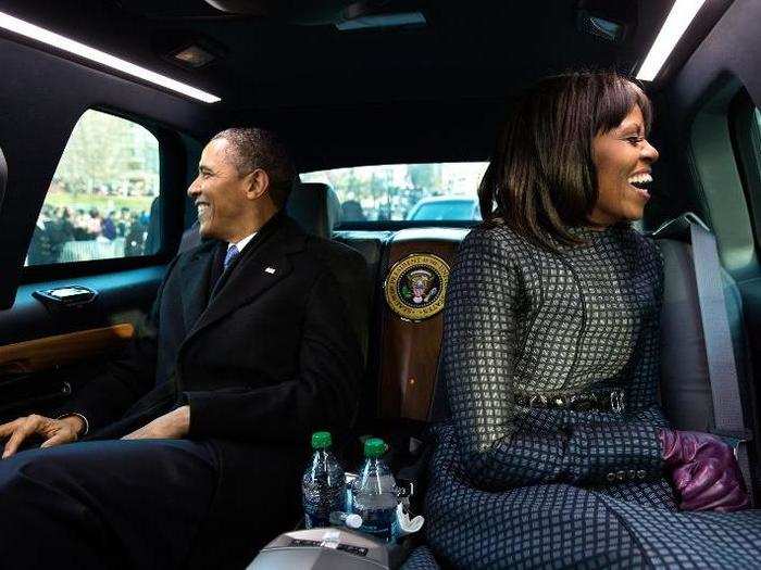 The Obamas wave and giggle as they ride in the inaugural parade in Washington, D.C., Jan. 21, 2013.