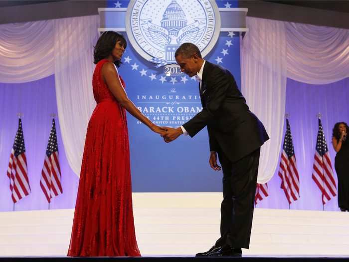 Barack bows in front of Michelle before they share their first dance during the Commander-In-Chief