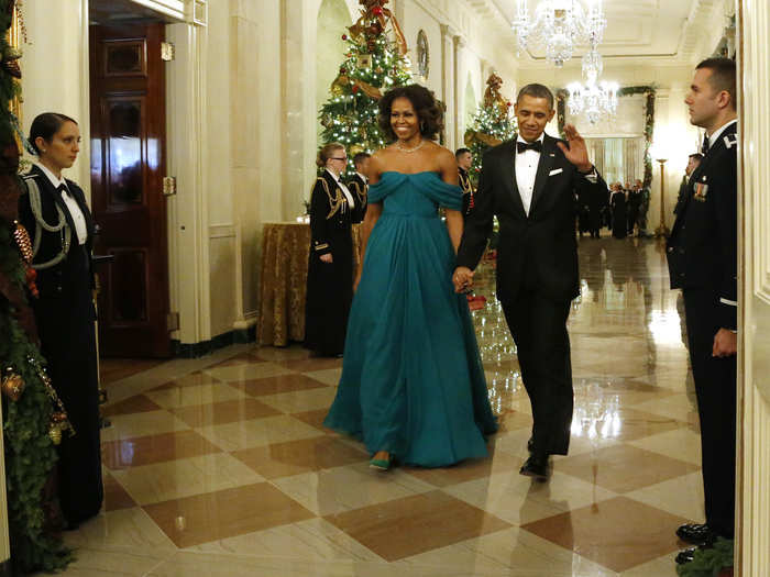 Barack Obama waves as he and Michelle arrive for a reception for the 2013 Kennedy Center Honors recipients.