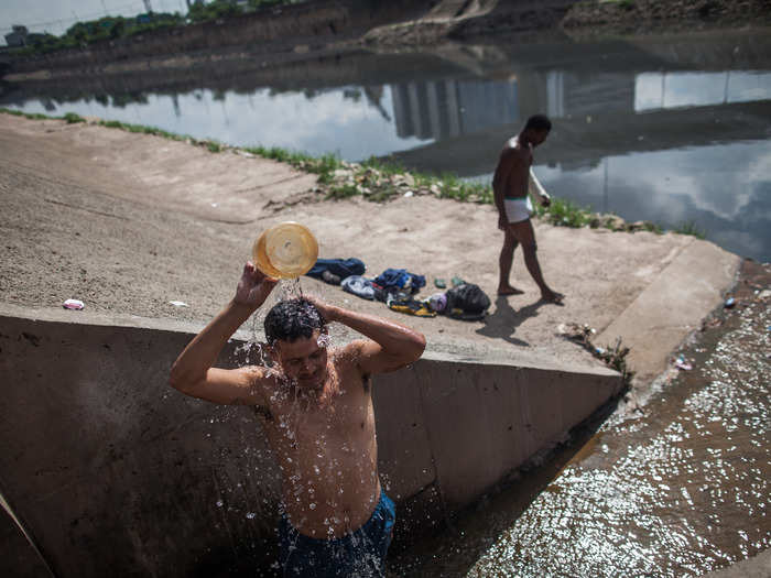 The Tietê and Pinheiros rivers that cross the city are so polluted that the smell alone can make passers-by sick — but they and the sewage pipes that feed into them are still the only water that some have access to, as shown here in this photo from April of 2014.