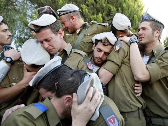 Israeli soldiers mourn during the funeral of their comrade Alex Mashavisky at a cemetery in Beersheba in this January 7, 2009 photo.