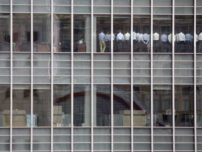 Staff members stand in a meeting room at Lehman Brothers offices in the financial district of Canary Wharf in London in September, 2008 during the stock market crash and financial crisis.