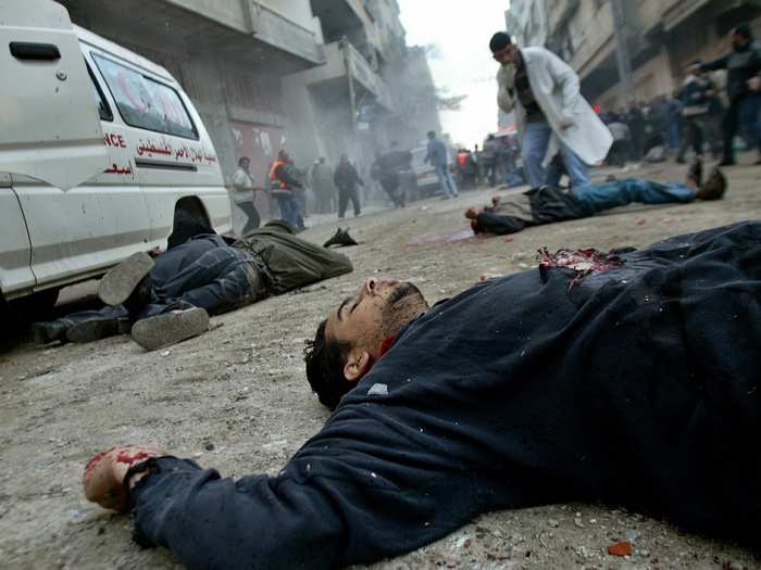 Unidentified bodies lie on a street in the Jabalya refugee camp in northern Gaza Strip in March 2003.