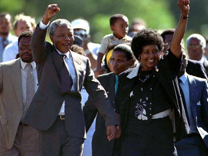 Nelson Mandela, accompanied by his wife Winnie, walks out of the Victor Verster prison near Cape Town after spending 27 years in apartheid jails on February 11, 1990.