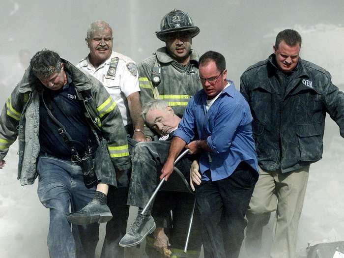 Rescue workers carry fatally injured New York City Fire Department Chaplain, Fether Mychal Judge, from one of the World Trade Center towers in New York, during the September 11, 2001 attacks on New York City.