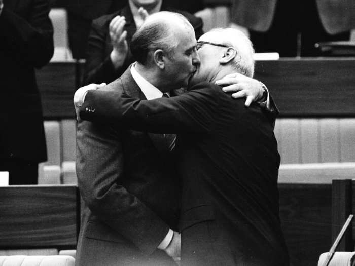 Soviet Leader Mikhail Gorbachev (L) congratulates East German Leader Erich Honecker with a kiss after Honecker