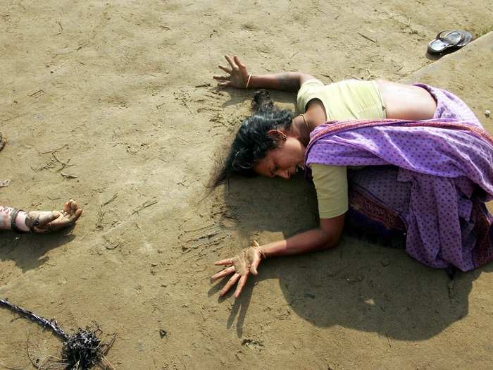 An Indian woman mourns the death of her relative (L) who was killed in the tsunami in Cuddalore, some 112 miles south of the southern Indian city of Madras in this December 28, 2004 photo. The South East Asia Tsunami killed 230,000 people in 14 countries, making it one of the deadliest natural disasters in recorded history.  Indonesia was the hardest-hit country, followed by Sri Lanka, India, and Thailand.